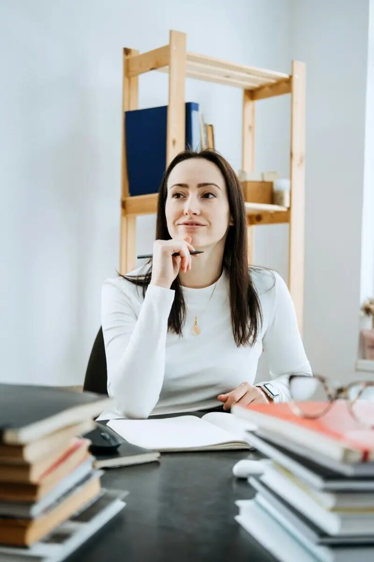 Account balance definition. Female Accountant working with many books and notepads