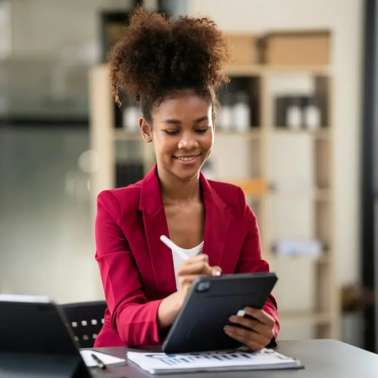 African american businesswoman in suit using tablet to reading a