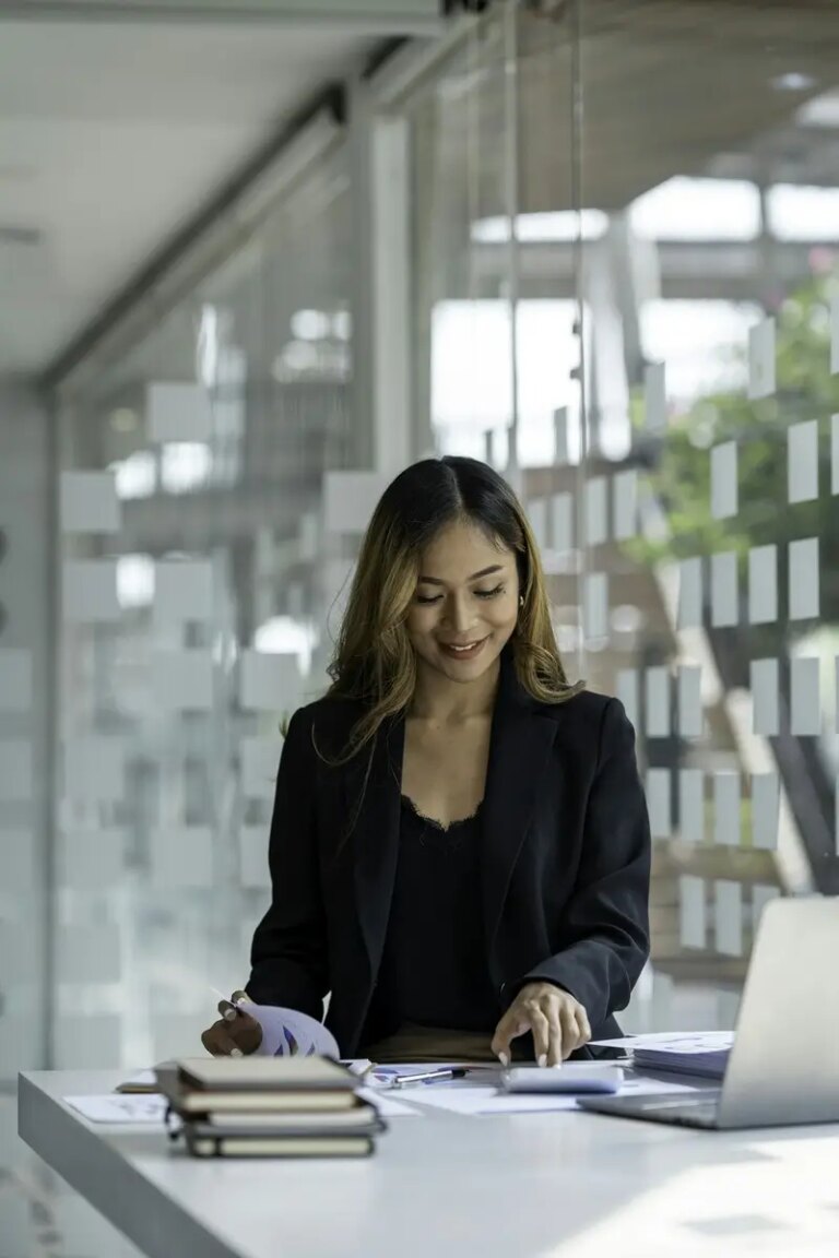 Asian businesswoman sitting working on laptop in office. tax, accounting, financial concept