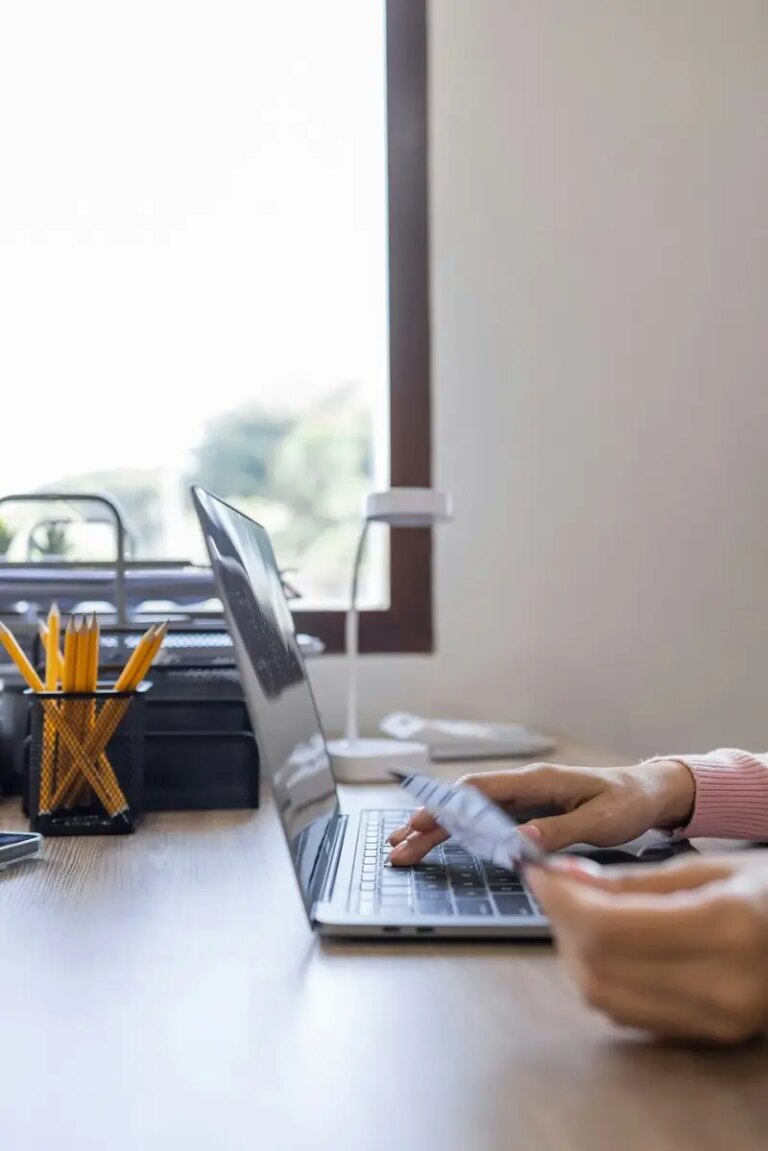 Asian woman hand using credit card and smartphone and laptop for buying online shopping payments