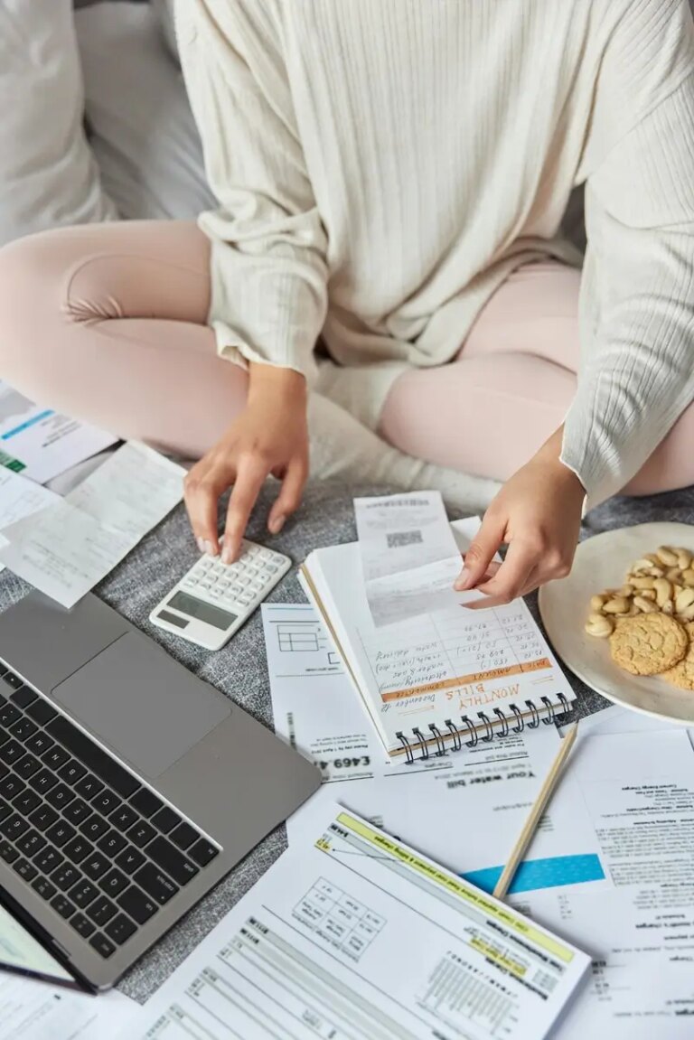 Cropped shot of unknown woman bookkeeper calculates domestic expenditures or taxes utility bills