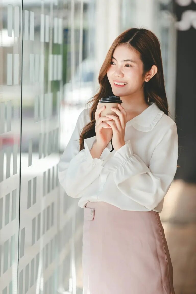 Portrait of an Asian woman working on a tablet computer in a modern office. Make an account analysis