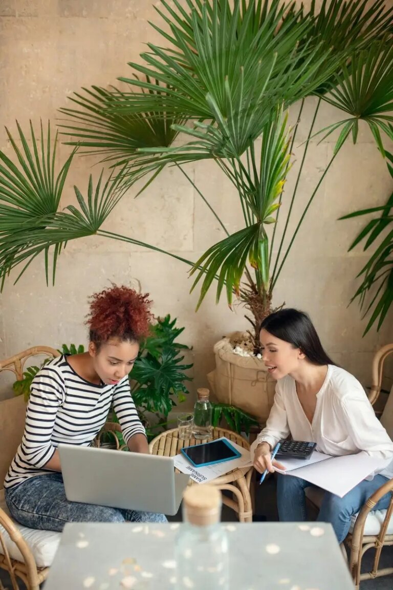 Two women feeling involved in making financial report