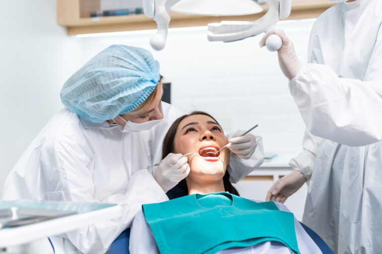 Caucasian dentist examine tooth for young girl at dental health clinic.