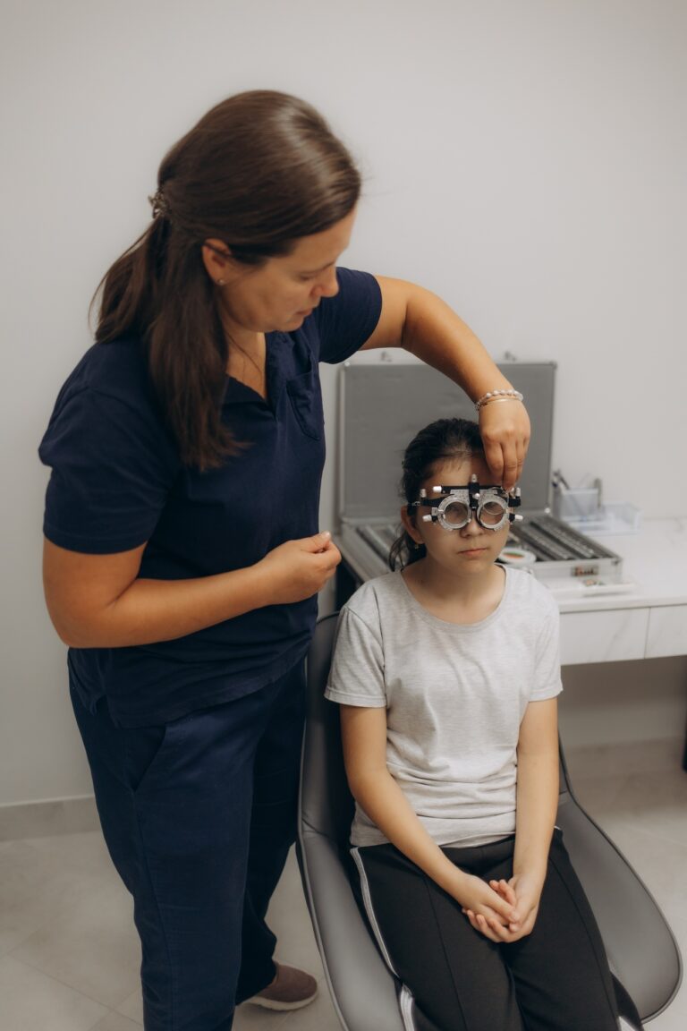 Optometrist examines the sight of young girl